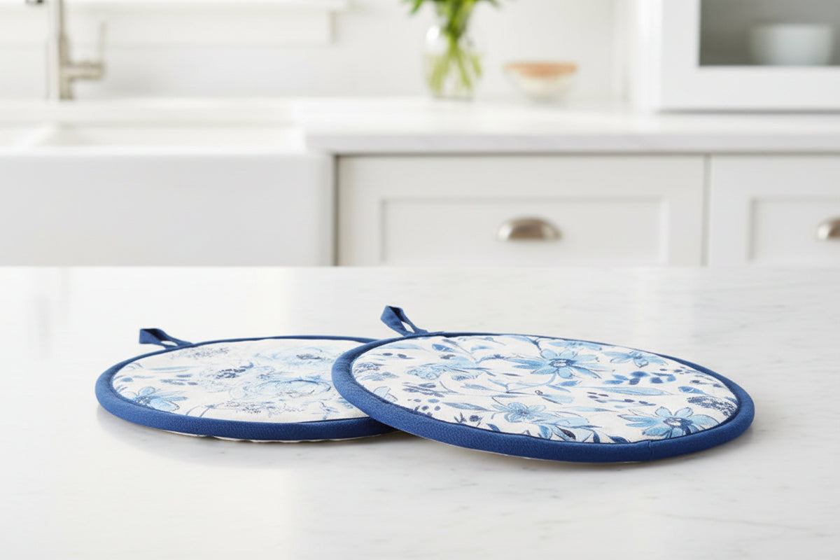 Two blue and white patterned pot holders on a white kitchen counter.