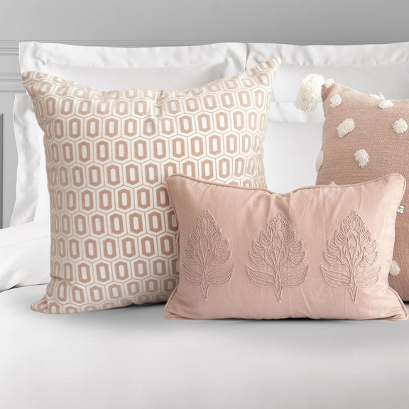 Odette rose patterned pillow cover styled on bed

